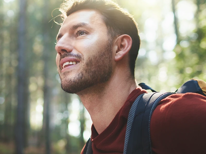 Person hiking through a forest